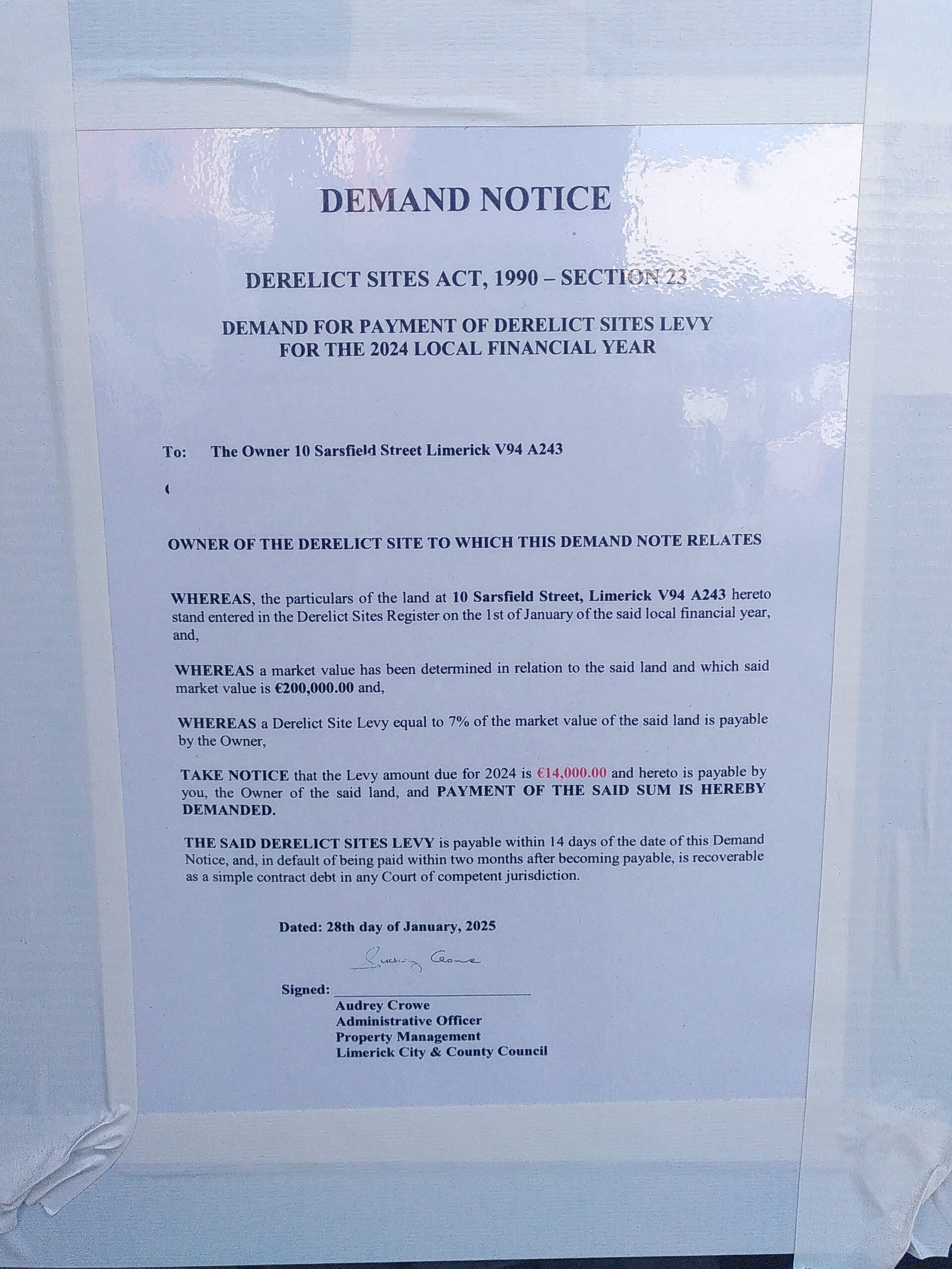 Notice for Demand of payment of derelict site levy of DS-033-23 An official Derelict Sites Notice for a Demand fo payment of derelict sites levy for the 2024 local financial year. The notice is laminated and framed with white tape.