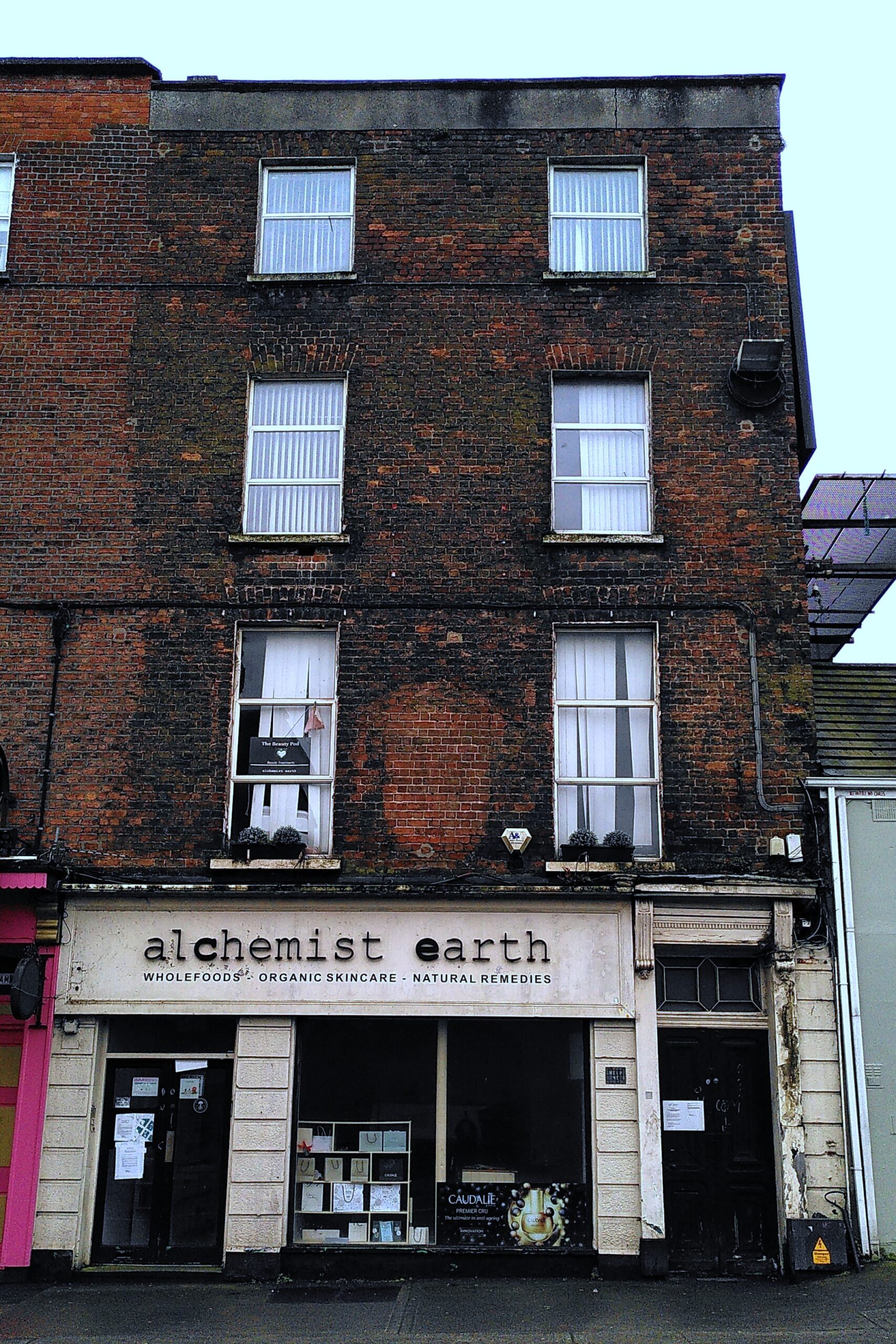 Derelict building located 10 Sarsfield Street (DS-033-23) 4 storey red and brown bricks building with an empty commercial unit on the ground floor still with the name of the previous business (alchemist earth). The building looks old and derelict.